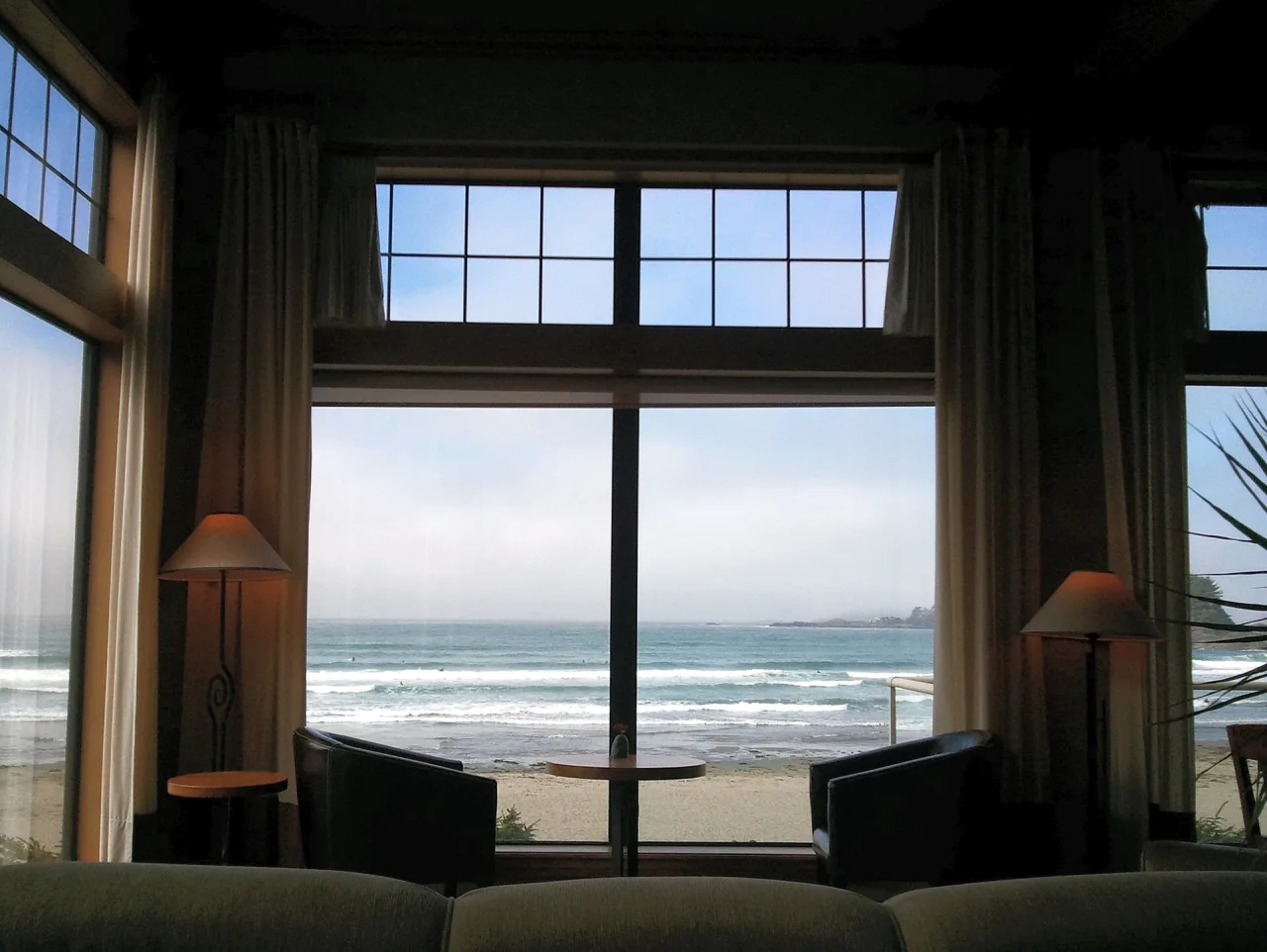 A tall picture window looking out at the ocean from the Great Room at Long Beach Lodge